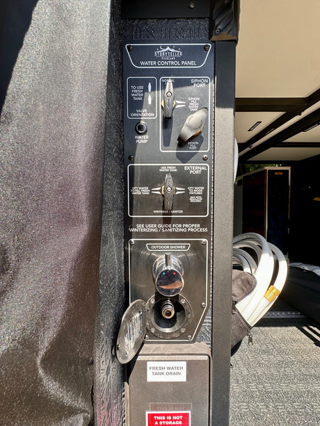 RV rental water control panel by Storyteller Overland, featuring fresh water, city water, siphon, and outdoor shower.