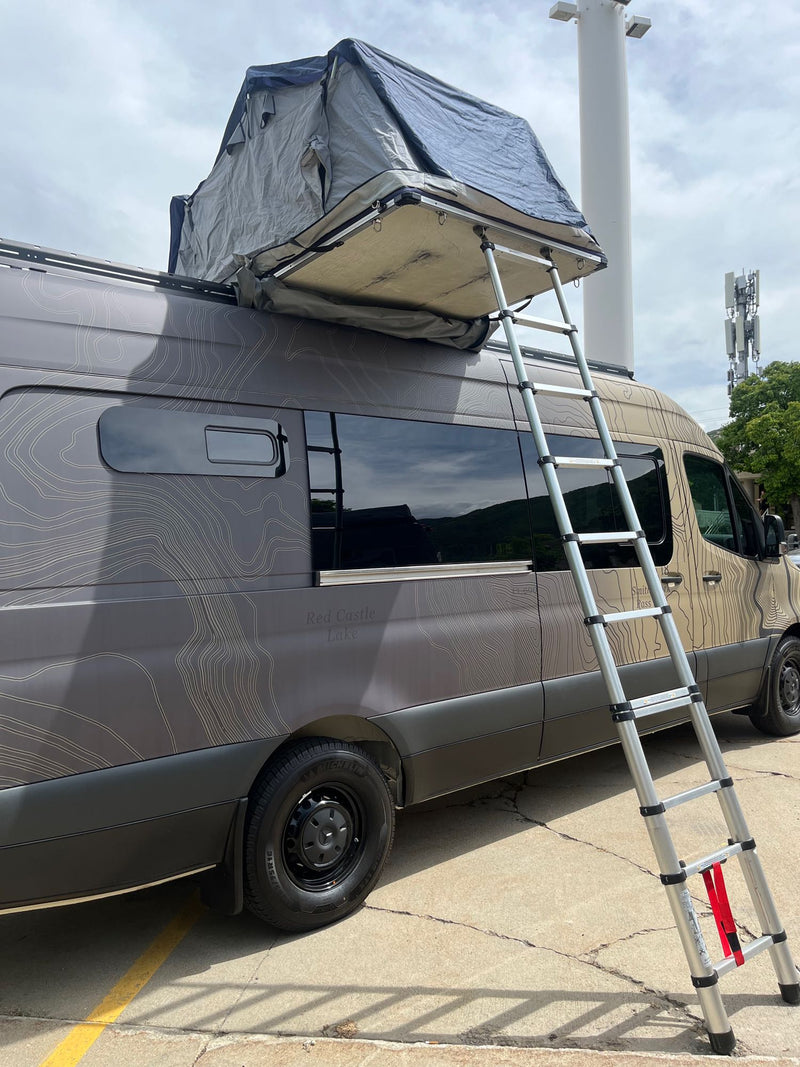  and comfy rear bed.|Tan & black custom Mercedes Sprinter van with a unique topographical map design — photo 18