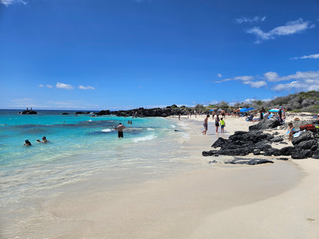 Stunning Hawaiian beach scene with clear turquoise water & white sand. Imagine a trip here via RV rental! Perfect vacation.