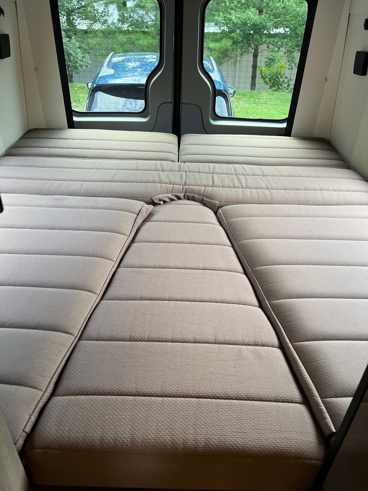  reveals its open side door and cozy interior.|Side view of a modern gray camper van — photo 9