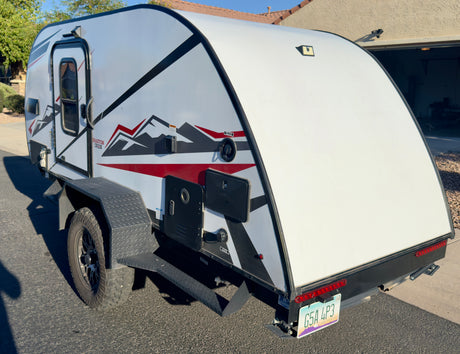 This compact teardrop travel trailer, ideal for an rv rental, is set for your next camping adventure.