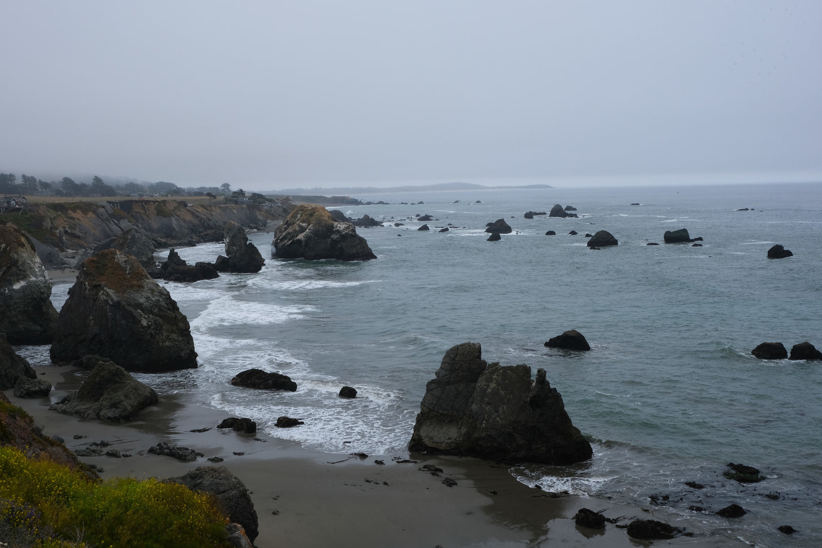 Rugged, misty Pacific coast with dramatic sea stacks & cliffs. Imagine an RV rental road trip along this scenic ocean vista.