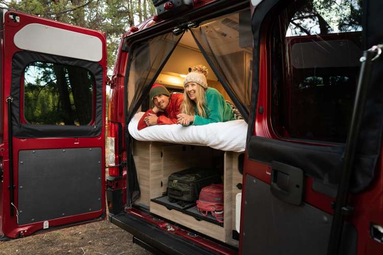  and grey floor.|RV rental interior showcases a compact kitchen with sink and stovetop