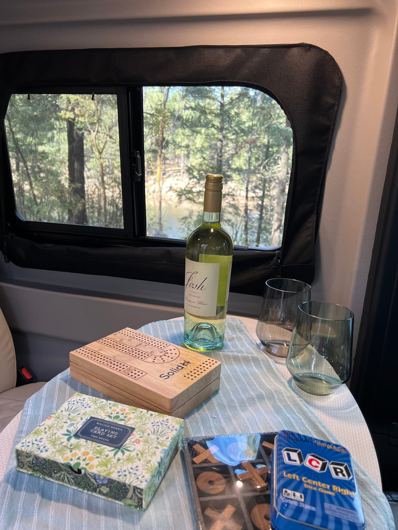  open to a scenic forest view through a bug screen.|Inside a spacious RV rental pop-top — photo 20