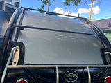 Rear view of a T@B camper with a roof rack, featuring a light grey roof and black body, ideal for rv rental.