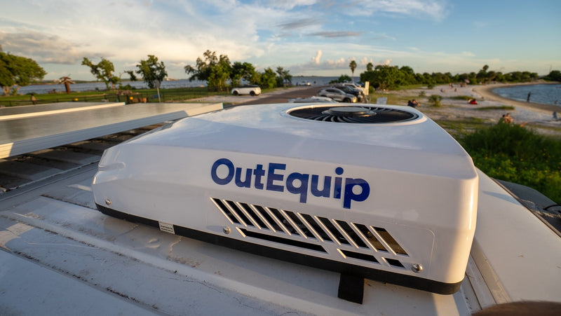An OutEquip rooftop AC on an rv rental, with solar power, provides comfort by a scenic beach at sunset. — photo 5