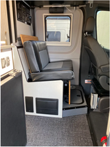 RV rental interior view showcasing a bench seat, window, and systems control panel.