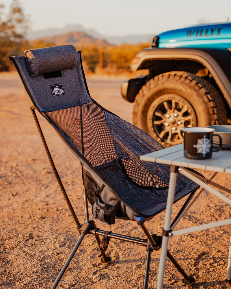 Relaxing outdoor setup: portable chair, table, and mug by a rugged vehicle, ideal for your next RV rental adventure. — photo 11