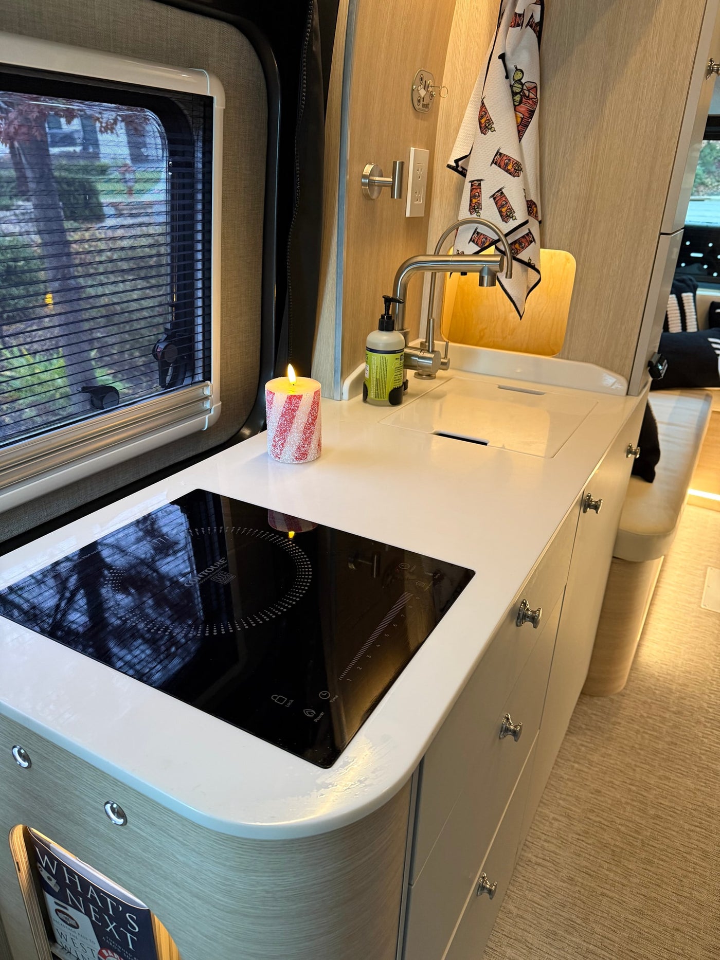 and sink area.|Cozy rv rental interior featuring a foldable wooden table — photo 6
