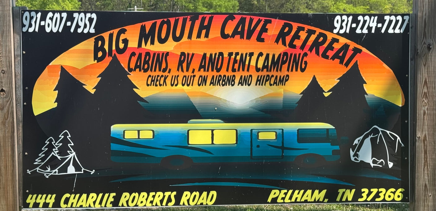 Sign for Big Mouth Cave Retreat: offers cabins, RV rental, and tent camping. Book on Airbnb & Hipcamp for a great stay.