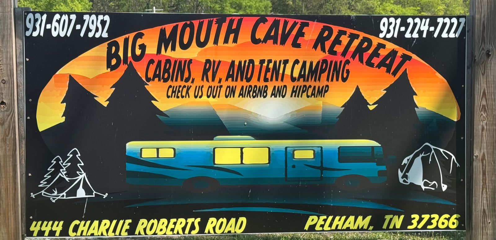Sign for Big Mouth Cave Retreat: offers cabins, RV rental, and tent camping. Book on Airbnb & Hipcamp for a great stay.