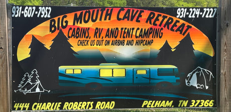 Sign for Big Mouth Cave Retreat: offers cabins, RV rental, and tent camping. Book on Airbnb & Hipcamp for a great stay.