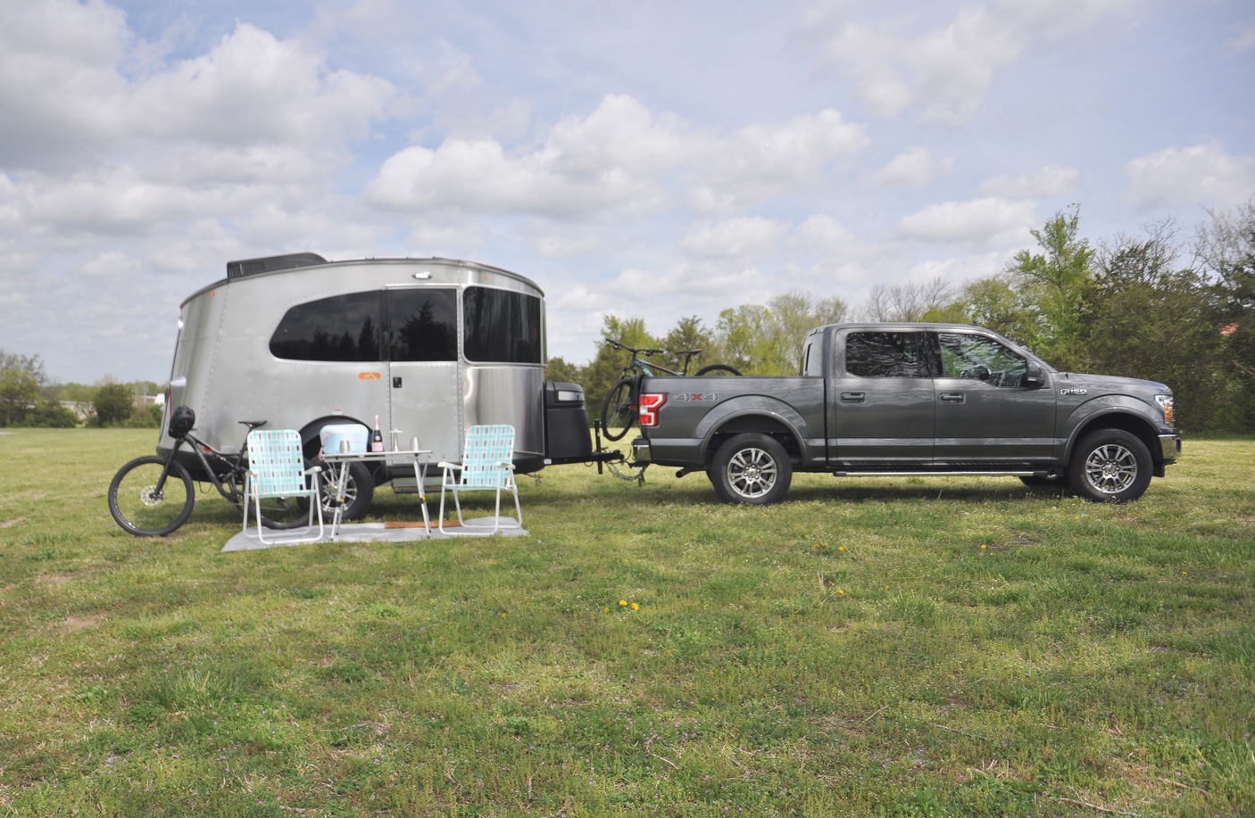 Spacious Airstream RV rental with truck and bicycles, ready for your outdoor adventure.