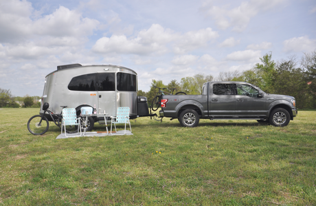 Spacious Airstream RV rental with truck and bicycles, ready for your outdoor adventure.