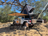 Adventure-ready Jeep Rubicon with rooftop tent and outdoor kitchen setup, ideal for your next RV rental camping trip!