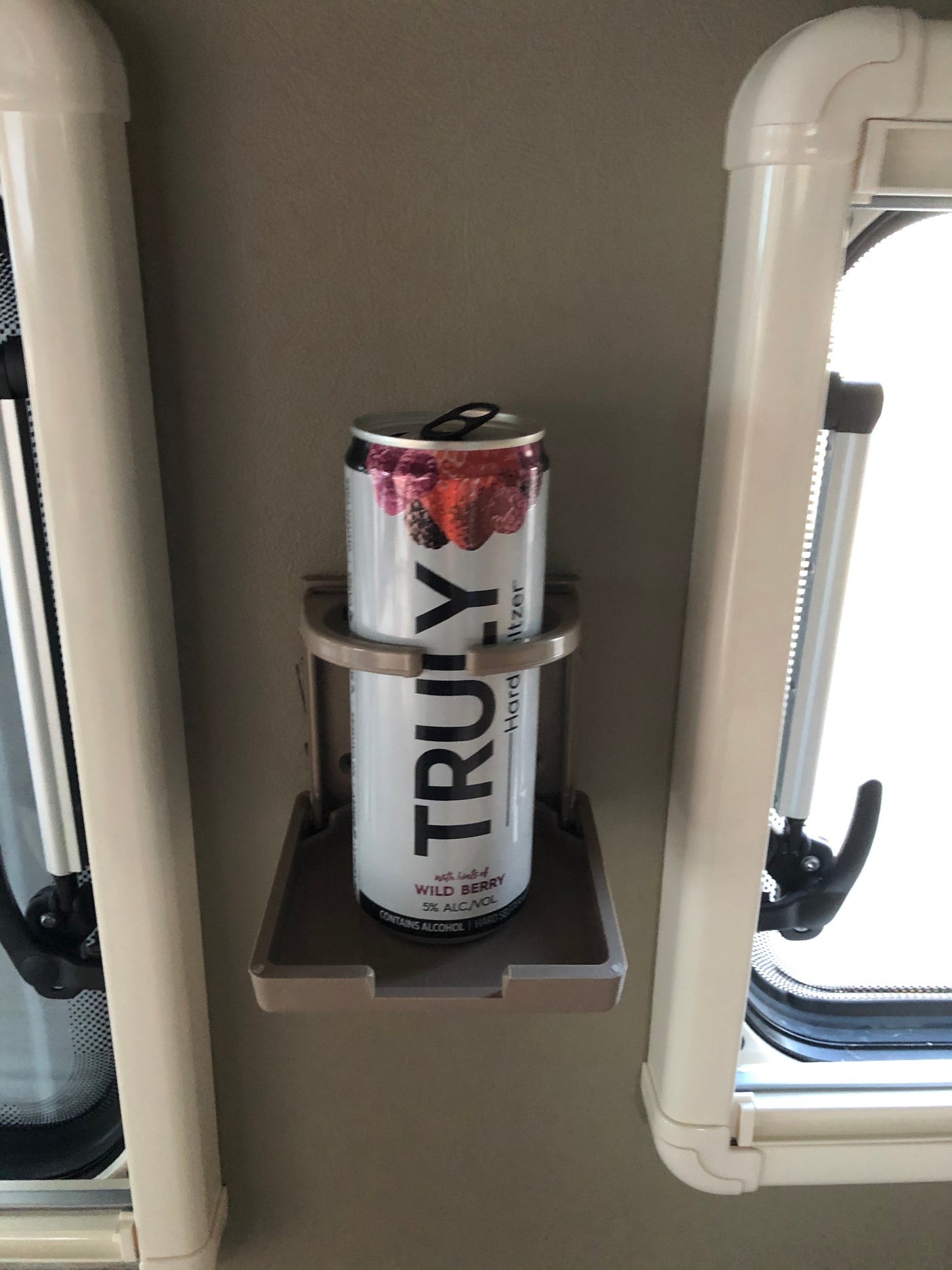 Enjoying a refreshing Truly Hard Seltzer in a convenient cup holder inside an RV rental. Perfect for travel!