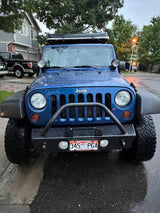 Front of a blue Jeep Wrangler with a roof tent, perfect for an RV rental and outdoor adventures.