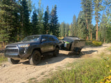 Explore off-road trails with a Toyota 4Runner towing an overland trailer. Consider this setup for an RV rental adventure!
