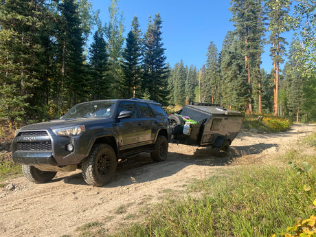 Explore off-road trails with a Toyota 4Runner towing an overland trailer. Consider this setup for an RV rental adventure!