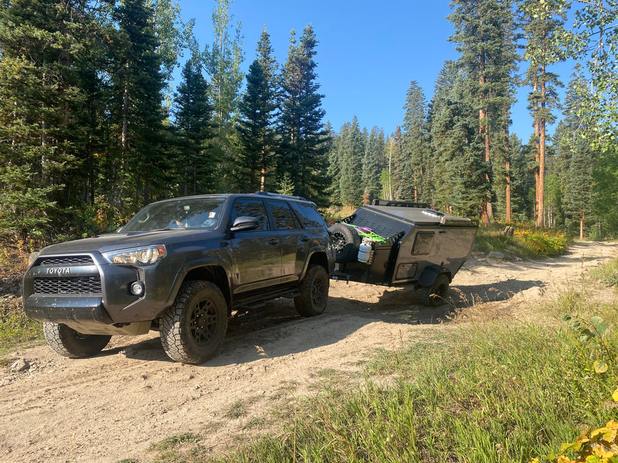 Explore off-road trails with a Toyota 4Runner towing an overland trailer. Consider this setup for an RV rental adventure!