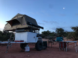 Rugged overland trailer with rooftop tent & camp kitchen at dusk. Great for exploring nature via RV rental.