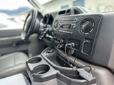 Inside an RV rental: detailed view of the dashboard, console, and tech accessories, perfect for your road trip.