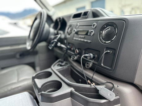 Inside an RV rental: detailed view of the dashboard, console, and tech accessories, perfect for your road trip.
