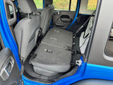 Interior of blue vehicle, rear seats folded flat. Spacious cargo area for an RV rental or adventure trip.