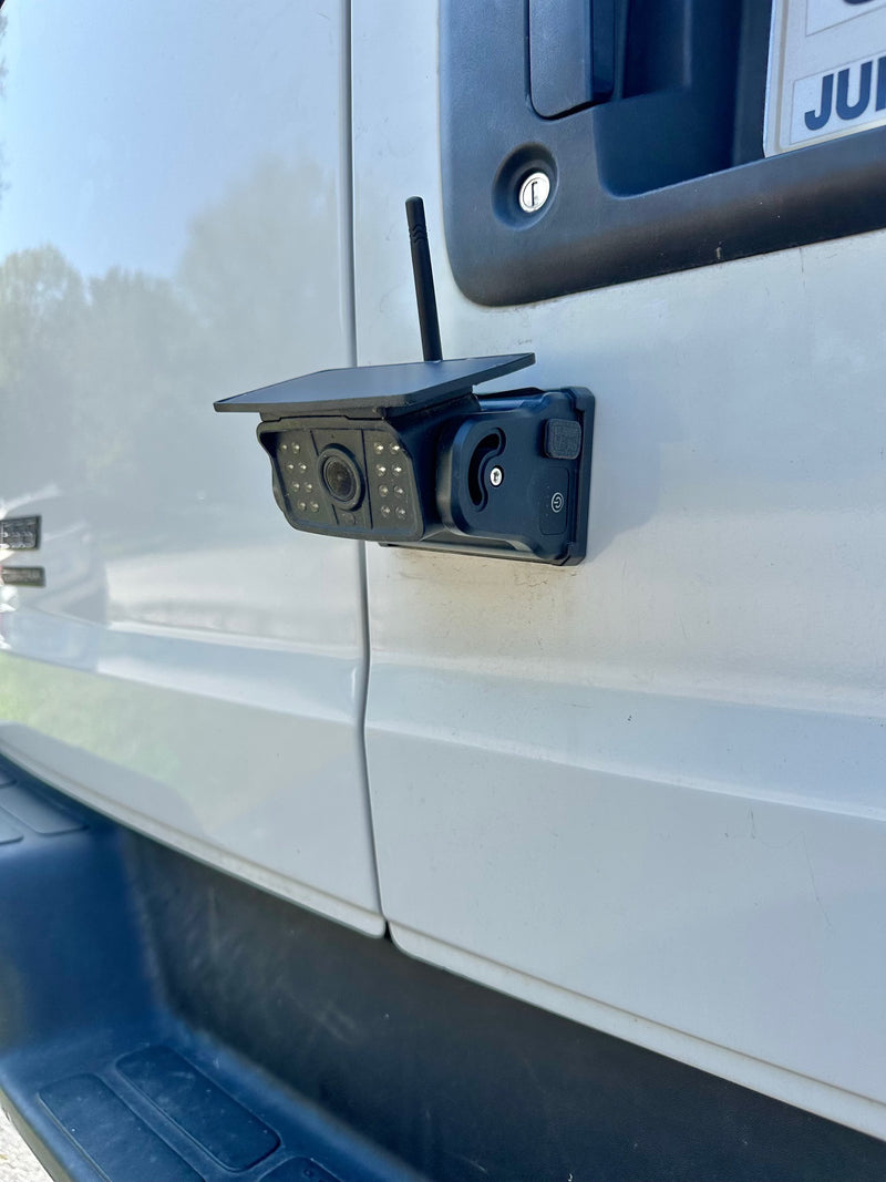 Close-up of a solar-powered security camera with an antenna on a white RV rental door, enhancing vehicle safety. — photo 8