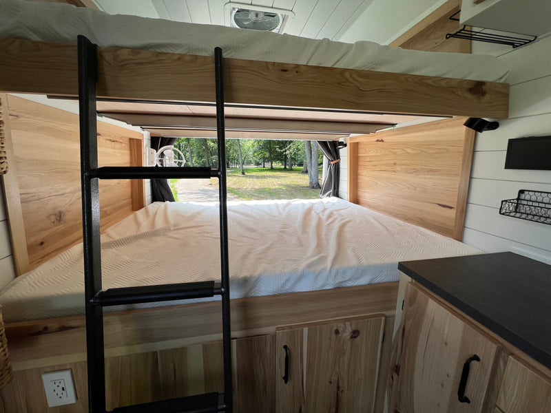  and seating.|Spacious RV rental interior: bunk beds — photo 8