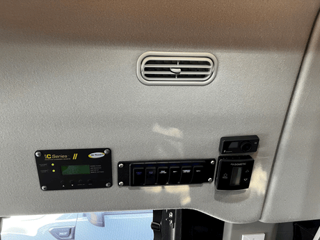 Overhead panel in an RV rental with Go Power inverter, Dometic climate, Eberspacher controls & light switches.