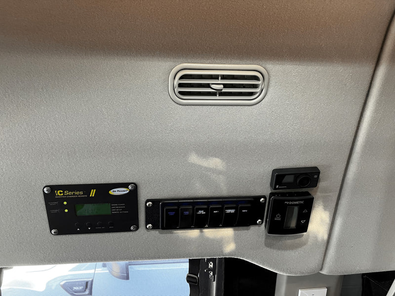 Overhead panel in an RV rental with Go Power inverter, Dometic climate, Eberspacher controls & light switches. — photo 11