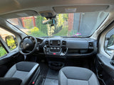 RV rental van interior showing dashboard, steering wheel, and front seats. Ready for adventure!