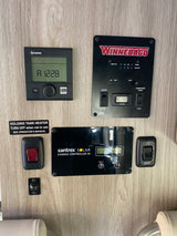 RV rental interior: A detailed RV control panel with Truma, Winnebago, & Xantrex displays for tanks, power, and heating systems.