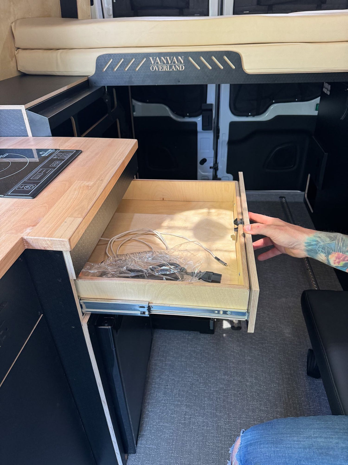  & system switches.|RV rental interior: A compact kitchen with a light wood countertop — photo 11