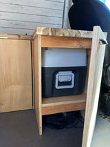 RV rental interior: A clever custom-built cabinet houses a portable toilet and practical storage for comfortable van life.
