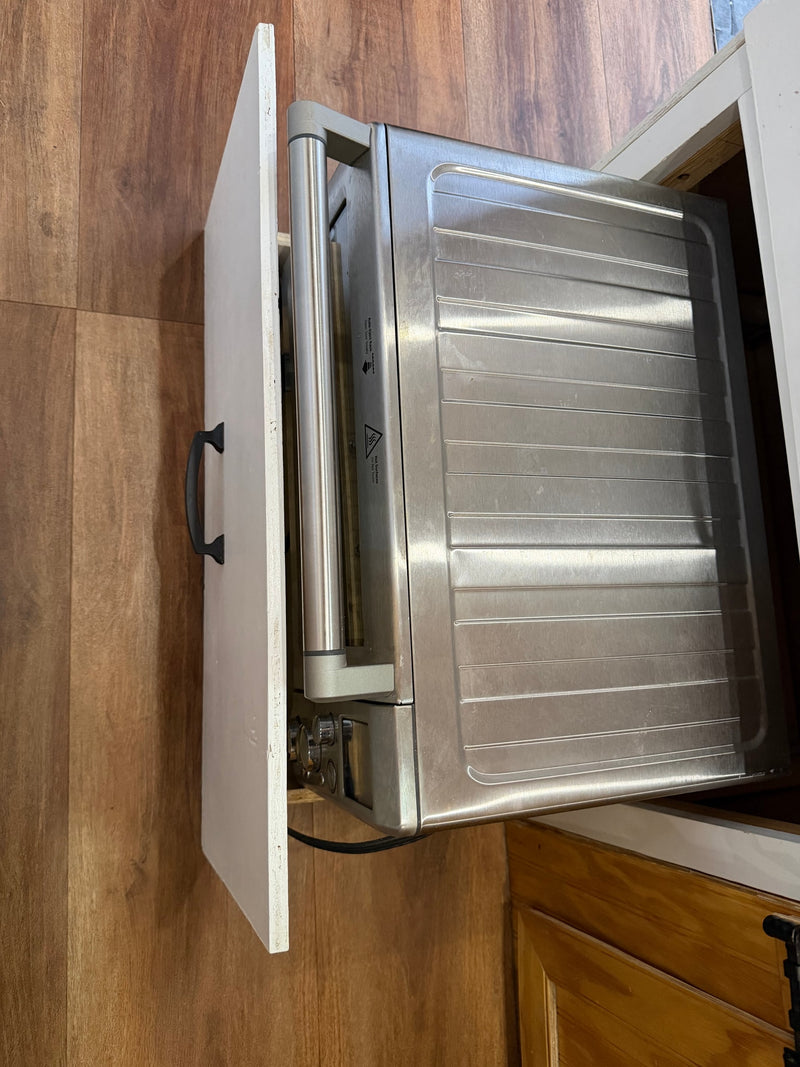 Stainless steel toaster oven, with hot surface warnings, pulled from compact rv rental kitchen storage. — photo 12