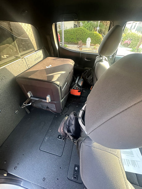 RV rental interior: Dometic fridge & Jackery power station secured in a custom cargo system. Ready for travel.