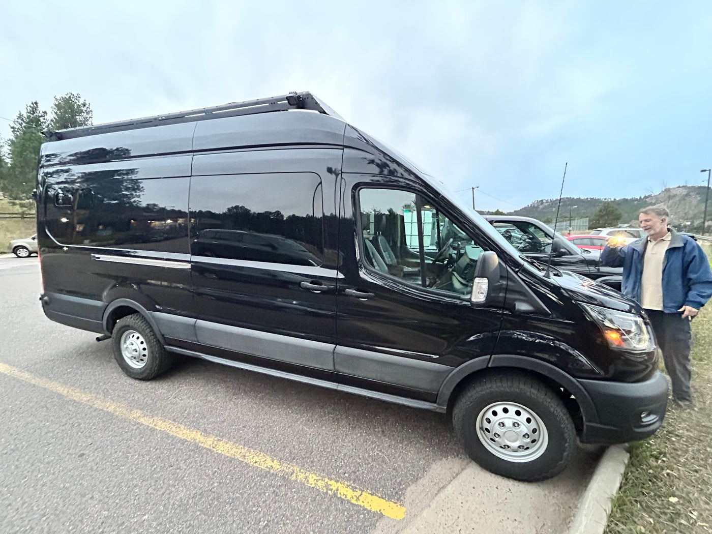  and ample storage for your journey.|Custom van interior for RV rental. Shows rear and front seating — photo 14