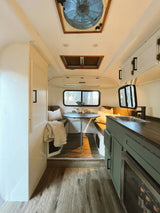 Step inside this modern RV rental! Features a cozy dining area, kitchen, and bright, inviting interior.