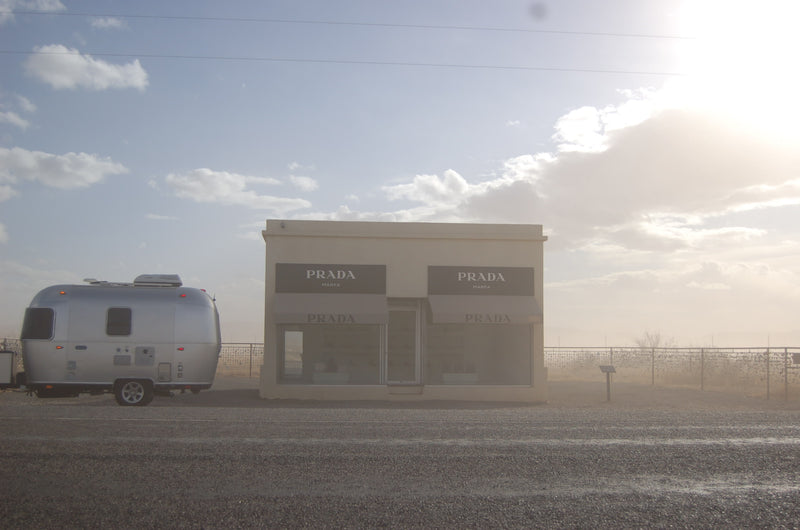 An RV rental, a silver Airstream, parked next to the famous Prada Marfa art installation in the Texas desert. — photo 2