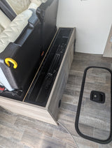 RV rental interior showing clever hidden storage for poles and a removed floor hatch cover, maximizing space.