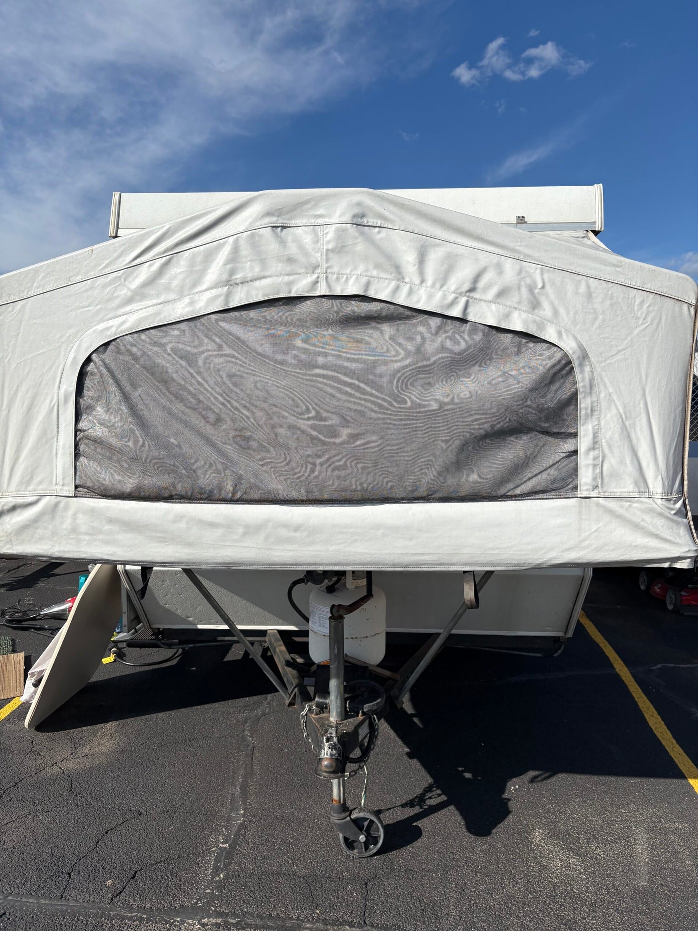 Front view of a white pop-up camper for RV rental, showing its fabric top, mesh window, and hitch. — photo 2
