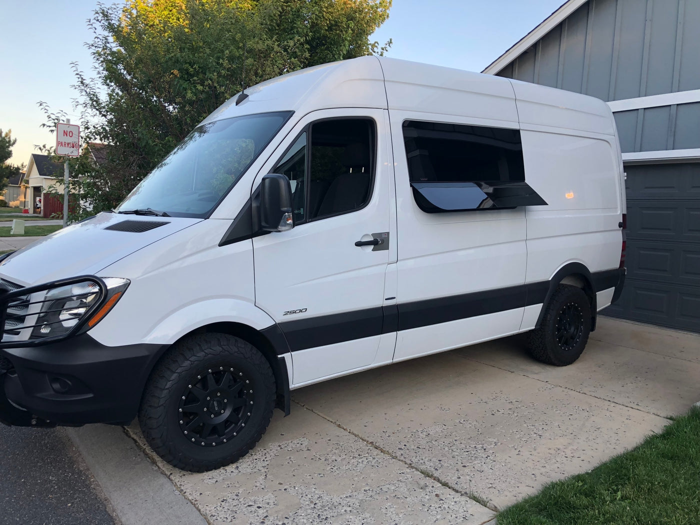 White Mercedes Sprinter camper van, ready for RV rental adventures, parked on a driveway. — photo 5