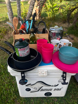 This rv rental ready setup features a portable kitchen with Coleman propane, pans, utensils, and dinnerware on a cooler for convenient outdoor cooking.