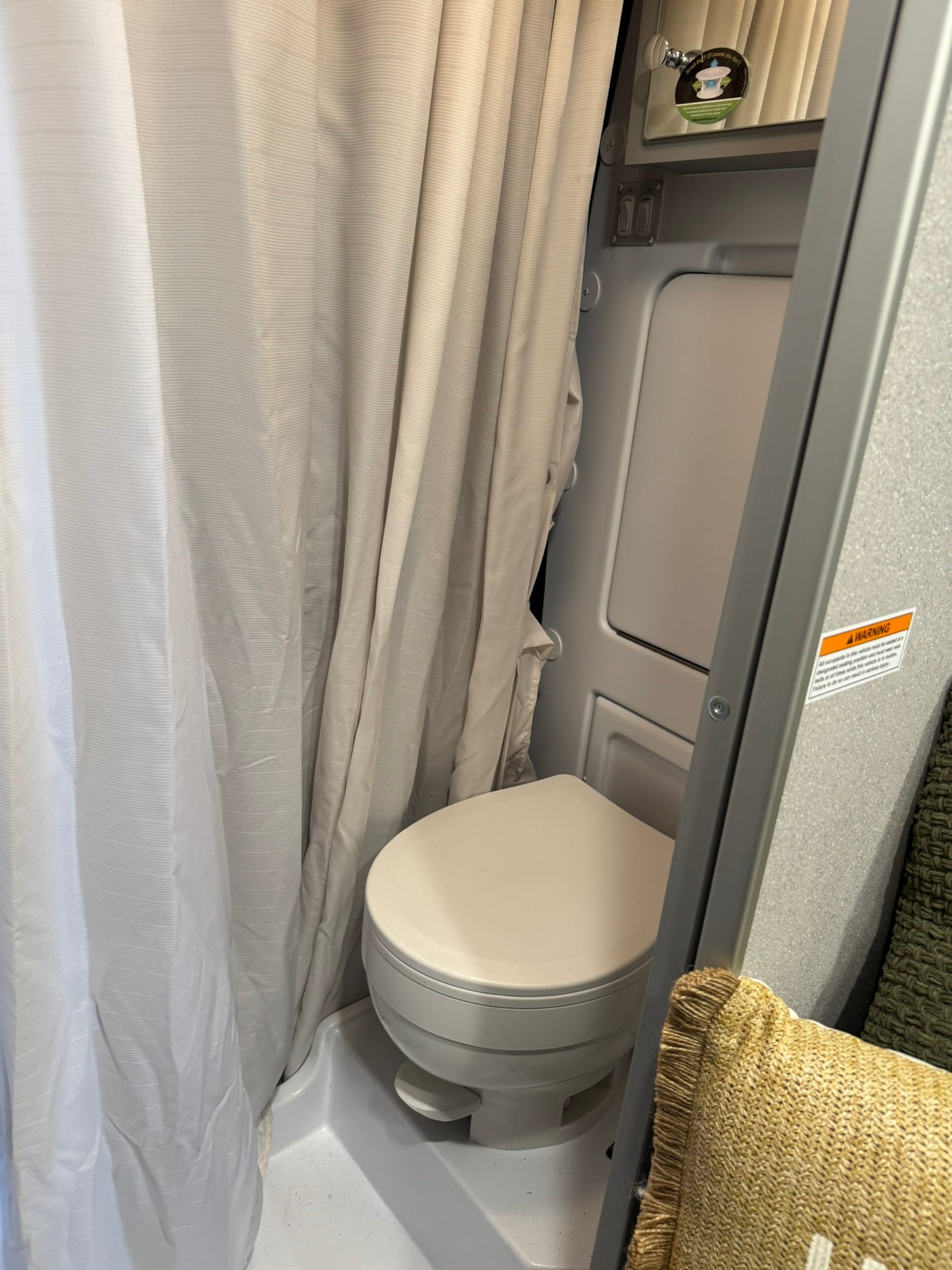  and overhead storage create a comfortable travel space.|This compact RV rental bathroom features a sink — photo 6