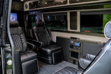 Step inside this luxury rv rental, featuring plush black leather captain's chairs and an entertainment system for comfortable travel.