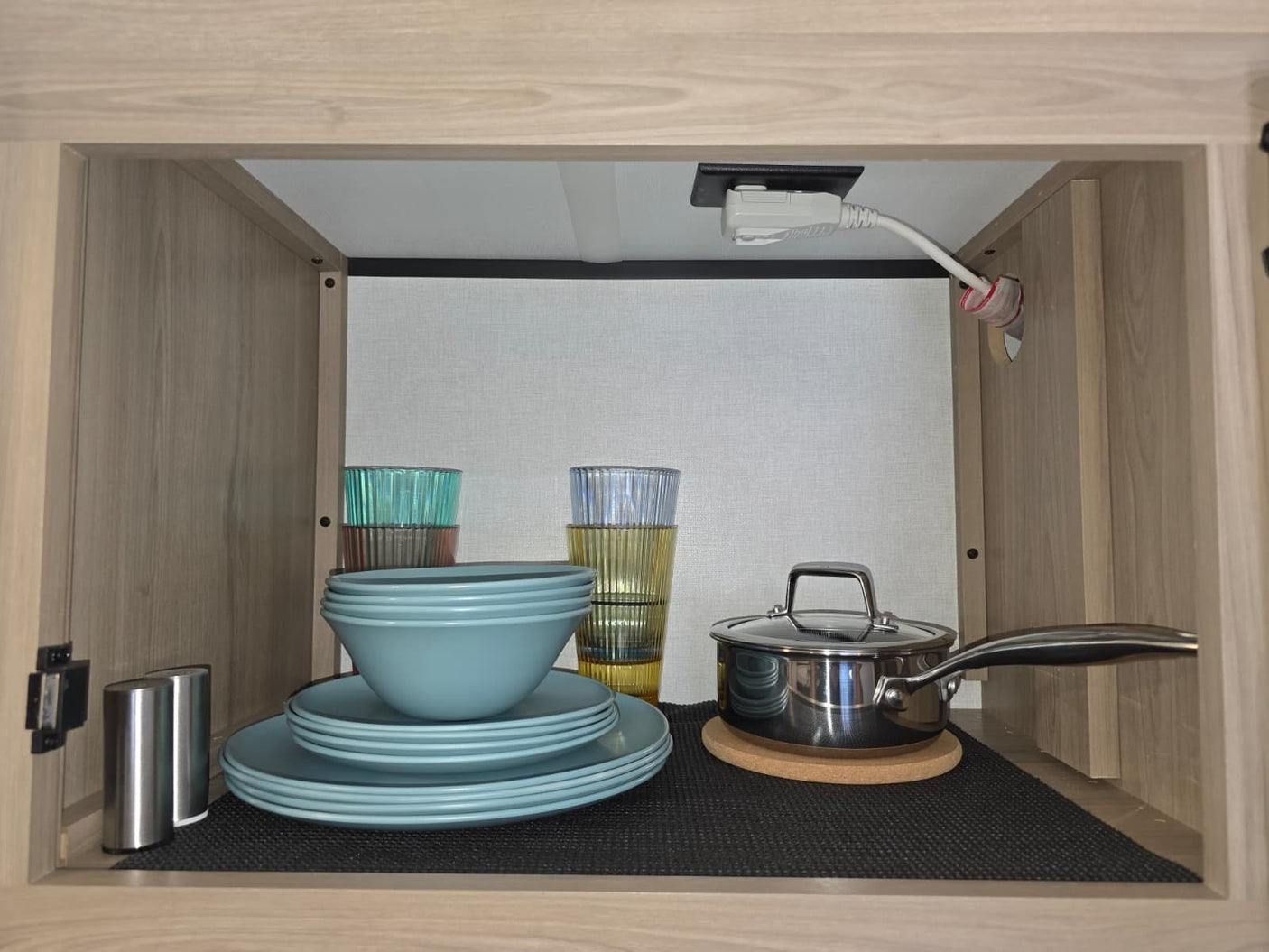  and a dark spoon on a non-slip mat.|Cozy rv rental features bunk beds