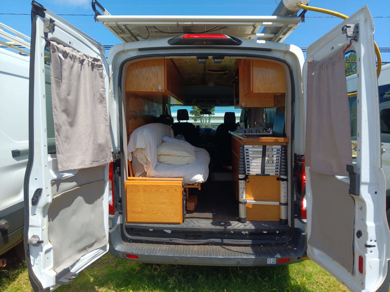 Inside this custom converted RV rental: a comfy bed, kitchen, and solar power for your mobile adventure. — photo 12