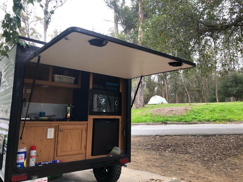  and overhead storage baskets.|Clean rv rental interior with comfy brown seating — photo 2
